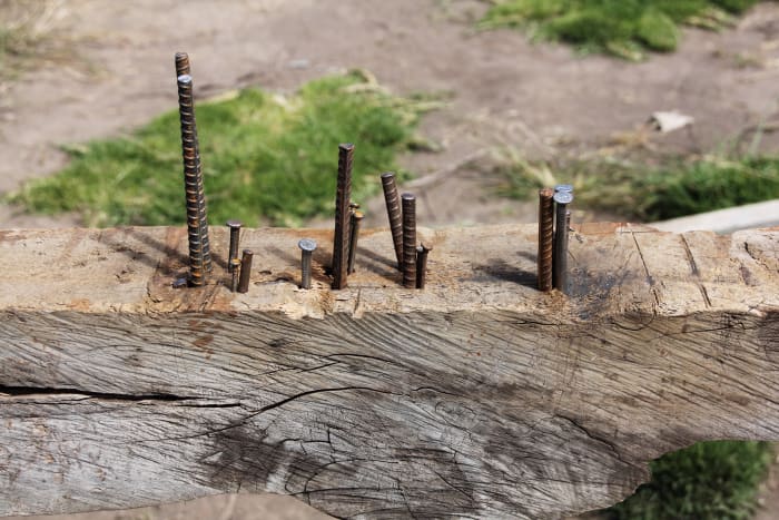 Wood beam with steel pegs and nails