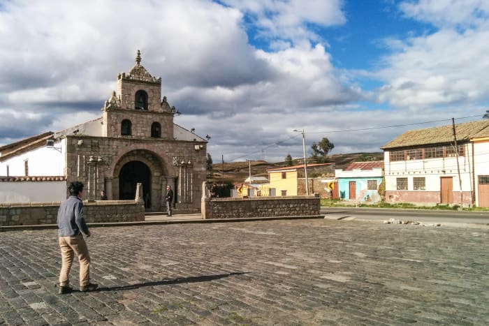 Church facade with large cobblestone plaza in front