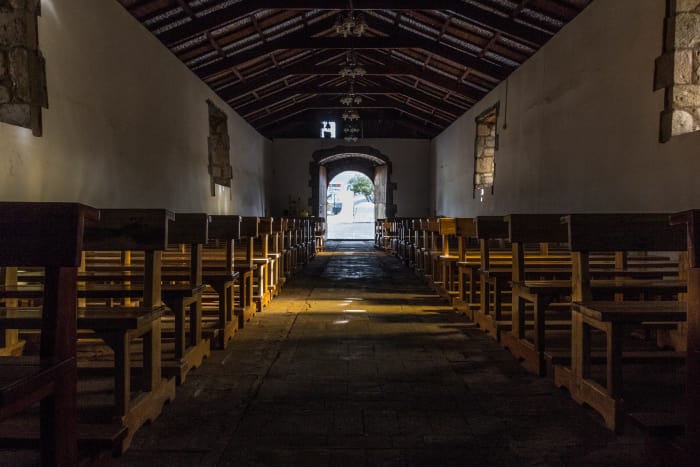 Church interior, from altar to entrance with rows of pews