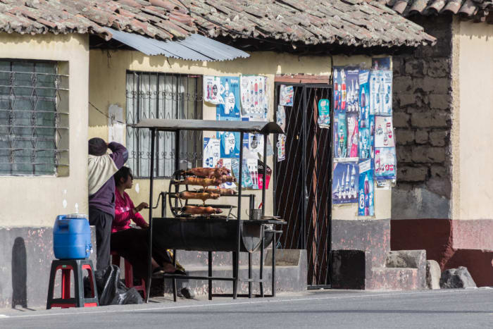 Roadside vendors with a BBQ spit selling guinea pigs