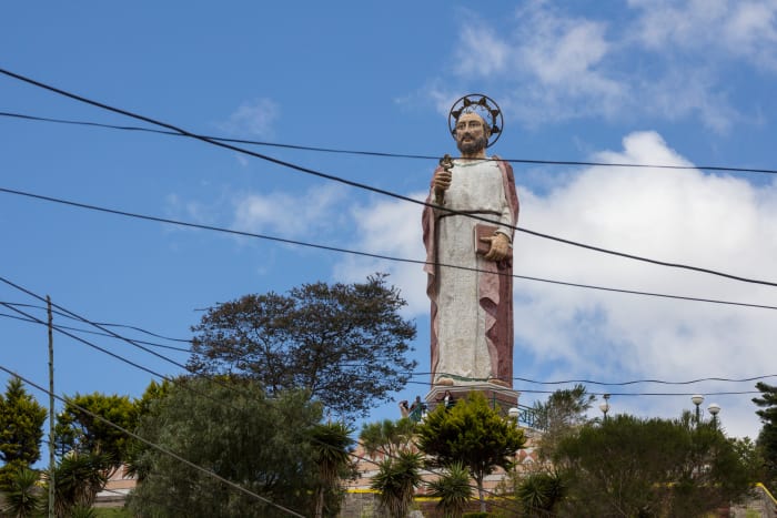 San Pedro statue on top of small hill, behind power lines