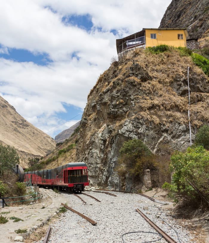 Train and tracks ending in gravel, with the café on the hillside