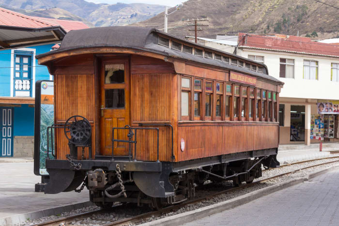 Wood train car on tracks beside the train station