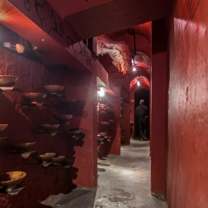 Dark red interior hallway corridor with art on walls