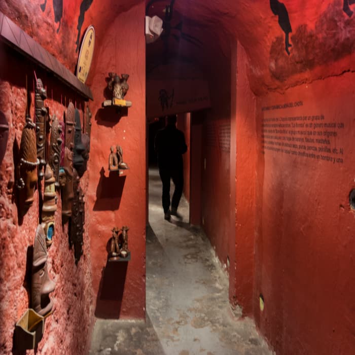 Dark red interior hallway with sculptures
