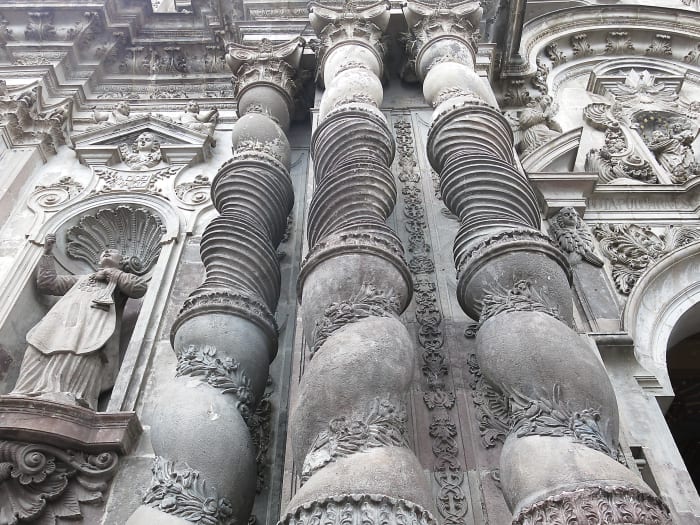Ornate carved stone columns on detailed church facade
