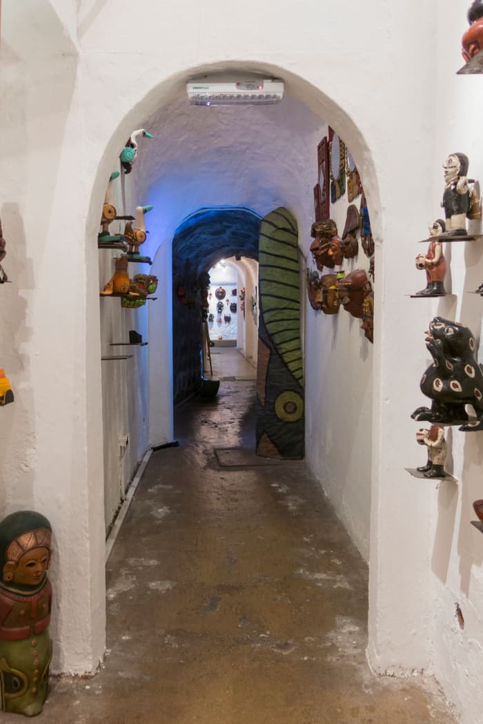White hallway tunnel with artwork on walls