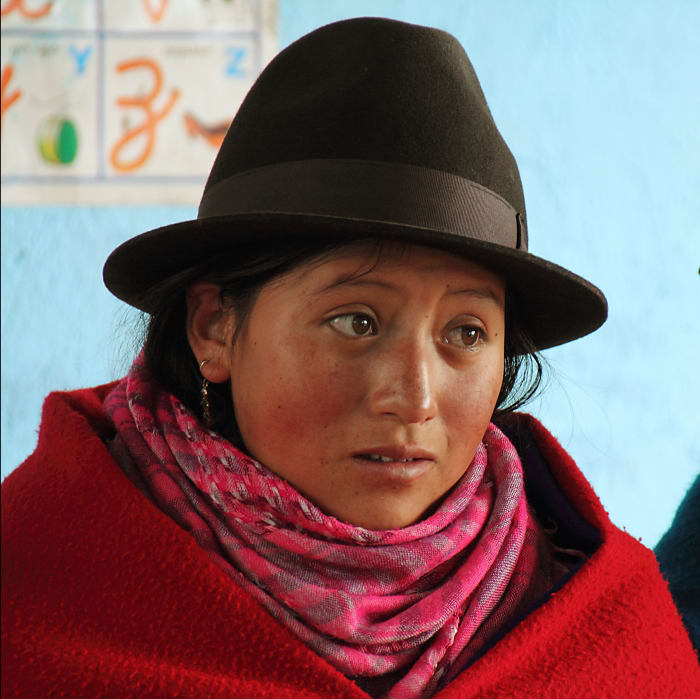 Indigenous girl portrait, wearing hat and poncho