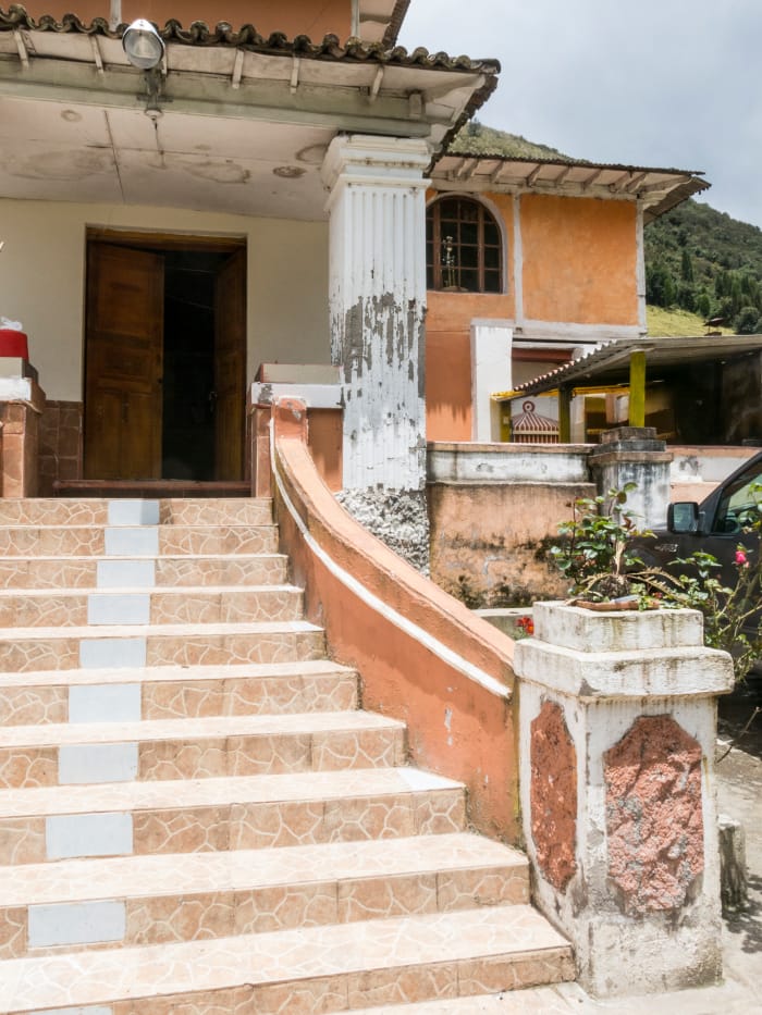 Villa front entry stairs, with peeling paint on a generally unmaintained building