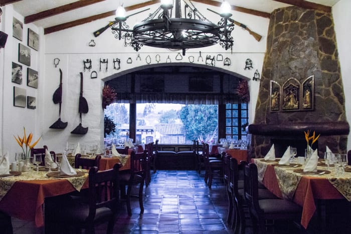Hotel dining room interior with mountain climbing expedition photos and objects hung on the walls