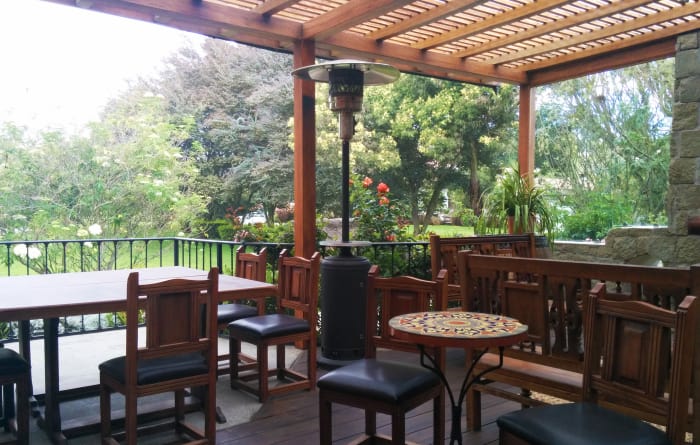 Outdoor patio overlooking the gardens with chairs and tables