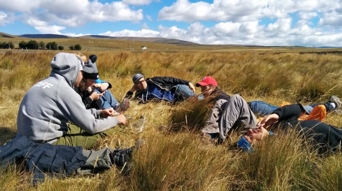 Group of people sitting in a field