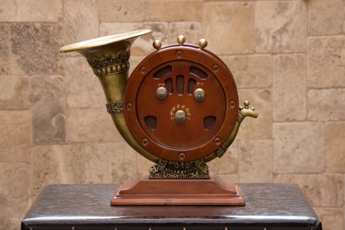 Antique AM/FM radio player with brass speaker horn
