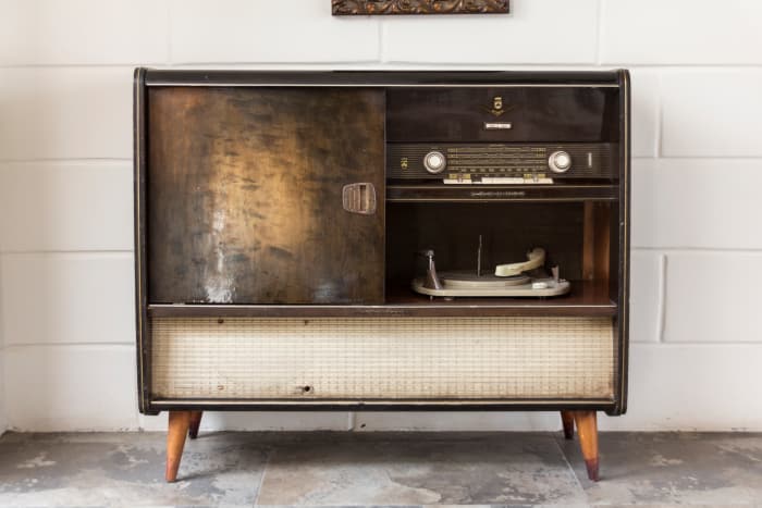 Antique stereo and record player against the wall