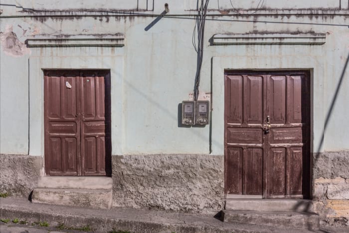 Wall with two sets of doors, one taller than the other